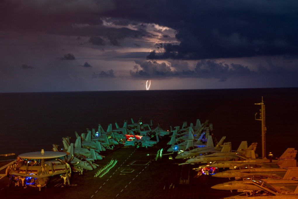 Lightning flashes over the US Navy aircraft carrier USS Nimitz as it transits the South China Sea on July 4. Photo: Reuters