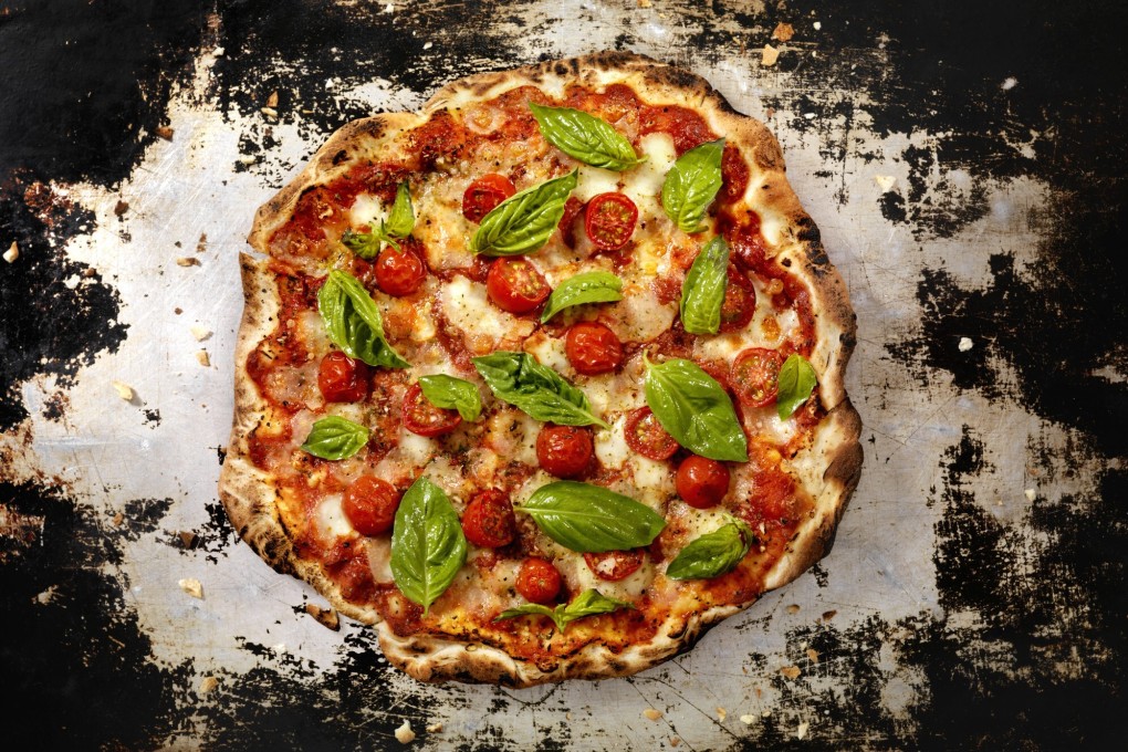 An authentic Neapolitan margherita pizza with mozzarella, tomatoes and basil. Teachers from Naples have shown disciples from Asia how to make the authentic pizza. Photo: Getty Images