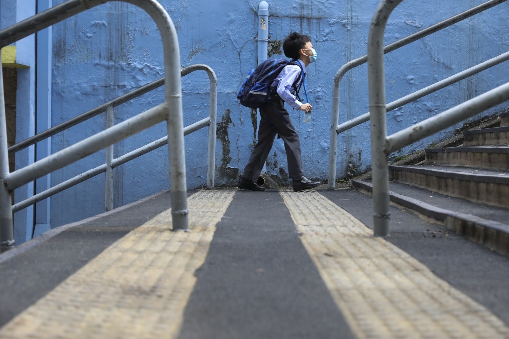 A boy makes his way to school on November 30 in Wan Chai. All schools will suspend face-to-face classes from Wednesday as the fourth wave of Covid-19 pandemic continues to worsen in Hong Kong. Photo: Nora Tam
