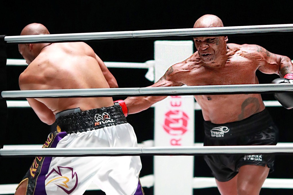 Mike Tyson (black trunks) throws a right hand at Roy Jones Jnr during the pair’s exhibition bout in Los Angeles. Photo: USA Today