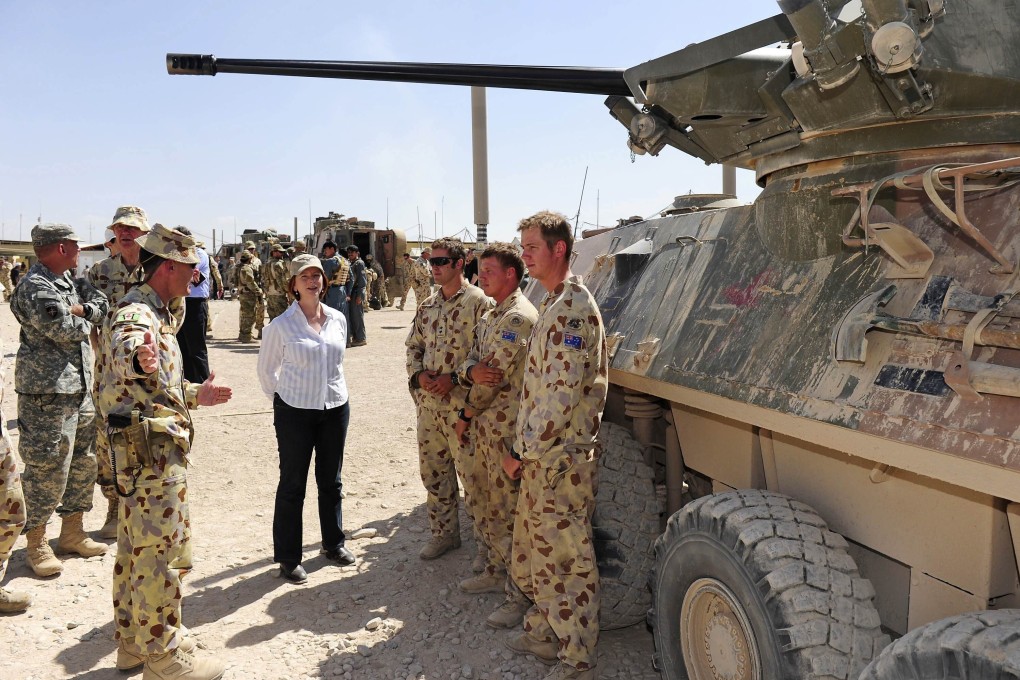 Former Australian prime minister Julia Gillard meets soldiers in southern Afghanistan in 2010. An independent report found evidence Australian soldiers illegally killed 39 Afghans. Photo: Reuters