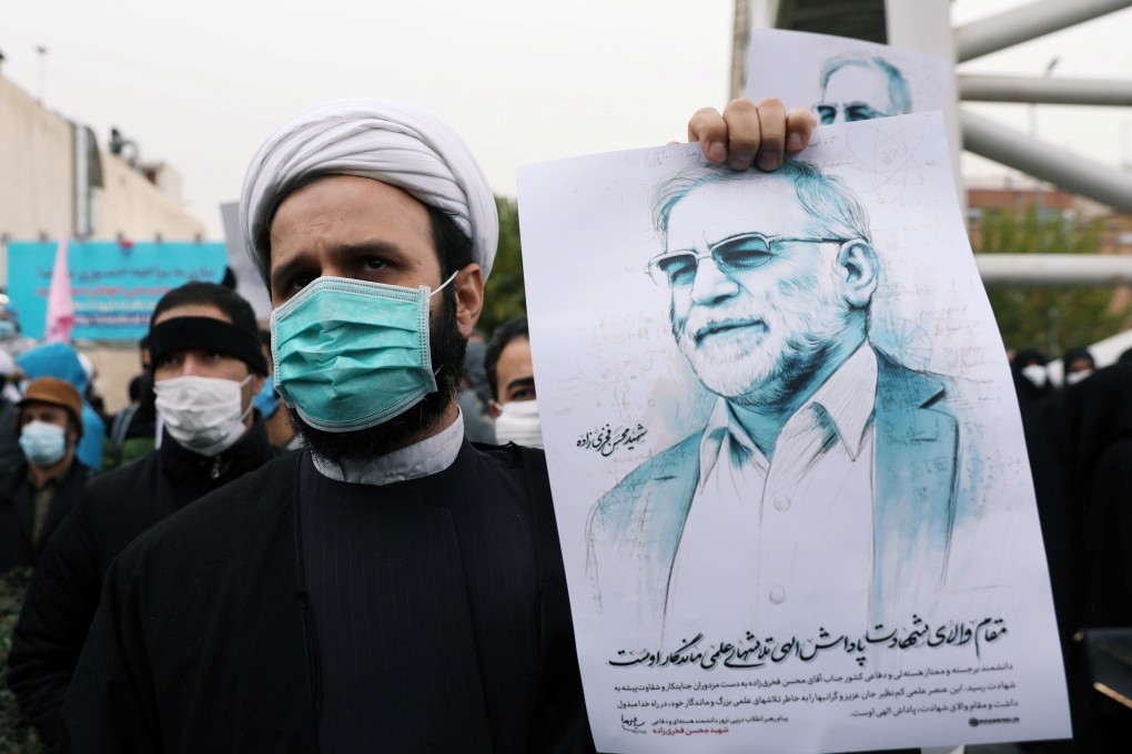 A protester holds a picture of slain Iranian nuclear scientist Mohsen Fakhrizadeh during a demonstration in Tehran. Photo: Reuters