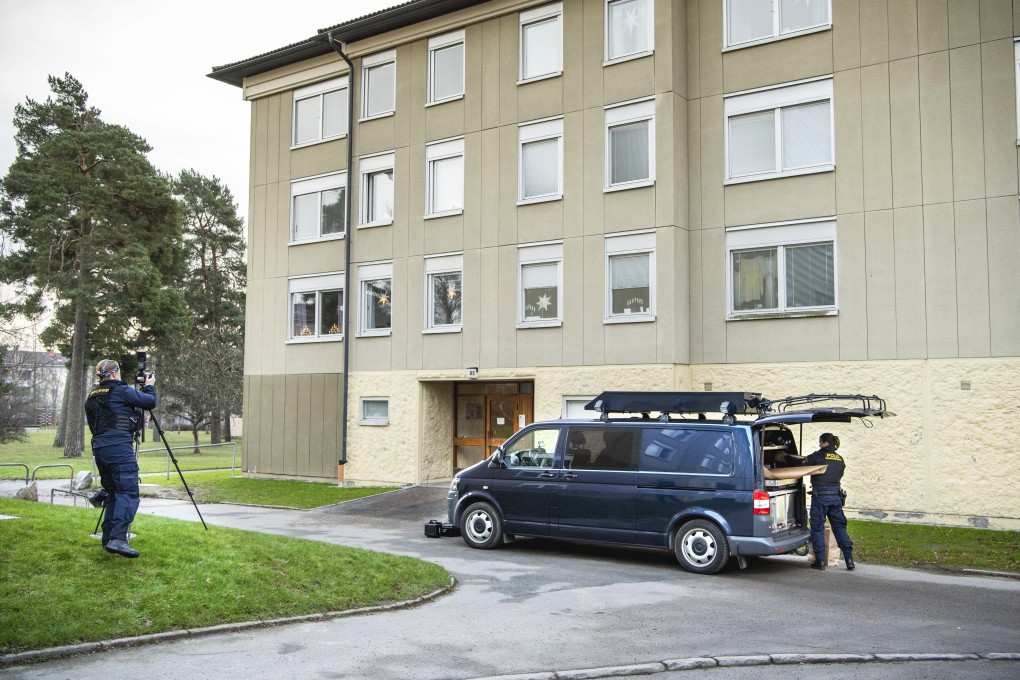 Police at the scene of a flat where a woman is suspected of locking up her son, in Haninge, south of Stockholm. Photo: AP