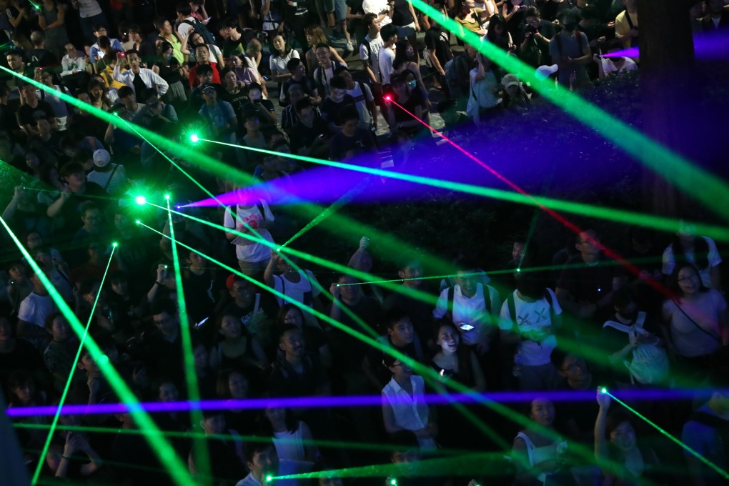 Anti-government protesters shine their laser pointers at the Hong Kong Space Museum, in Tsim Sha Tsui. Photo: Sam Tsang