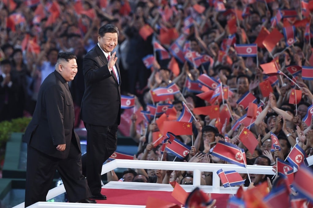 Chinese President Xi Jinping walks with North Korean leader Kim Jong-un during a visit to Pyongyang in June last year. Photo: Xinhua