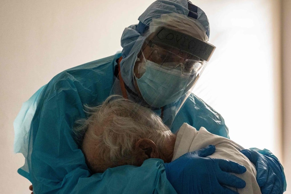 Dr Joseph Varon comforts the elderly patient in the Covid-19 intensive care unit at the United Memorial Medical Centre in Houston, Texas. Photo: AFP