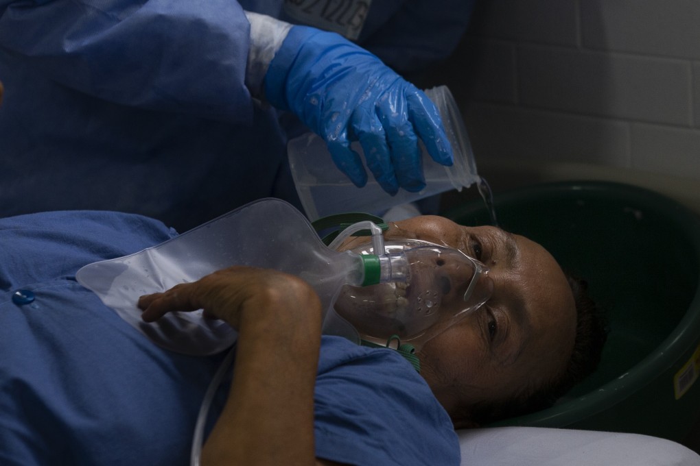 A medical worker washes a patient's hair, at a military hospital set up to take care of Covid-19 patients in Mexico City. Photo: AP