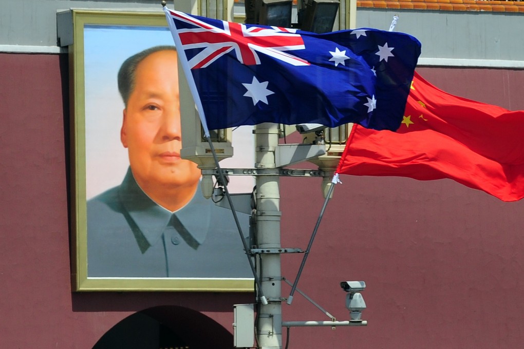 The national flags of Australia and China are displayed in front of a portrait of Mao Zedong in Tiananmen Square, Beijing, during a visit by Australia’s then prime minister Julia Gillard to China on April 26, 2011. Photo: AFP
