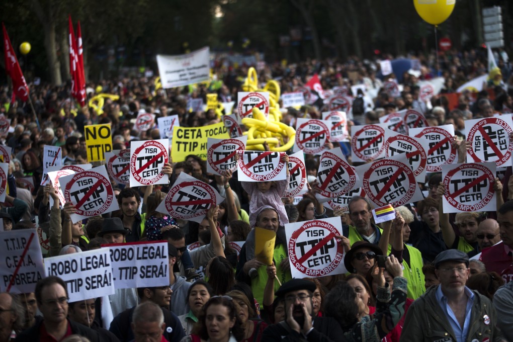 People hold up posters against the Transatlantic Trade and Investment Partnership (TTIP) during a protest in Madrid, Spain, on October 15, 2016. Attempts to revive the deal under US President-elect Joe Biden are likely to receive intense resistance from politicians and the public on both sides of the Atlantic. Photo: AP