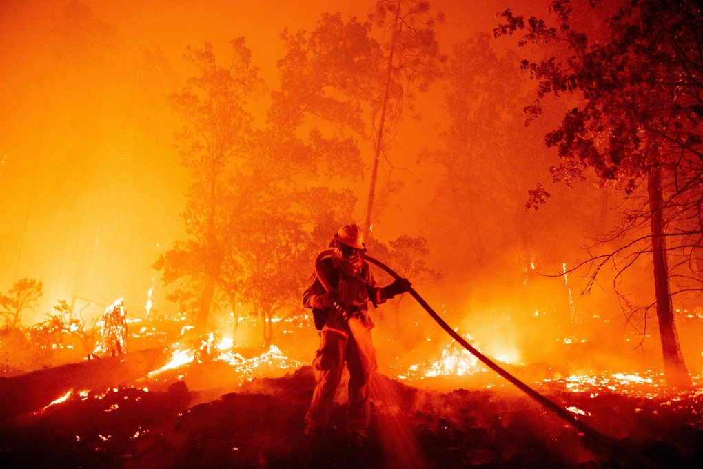 A firefighter douses flames in California in September. Wildfires consumed vast areas in Australia, Siberia, the US West Coast and South America during the year, sending plumes of smoke circumnavigating the globe. Photo: AFP