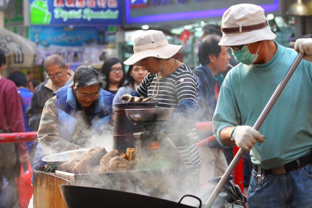 A Hong Kong hawker sells sweet potatoes, a popular snack in the city during winter. Photo: Shutterstock