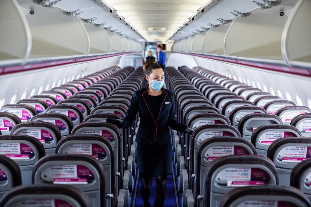 A member of the cabin crew wears a face mask as she checks seating on a passenger plane at Liszt Ferenc airport in Budapest, Hungary in May. Photo: Bloomberg