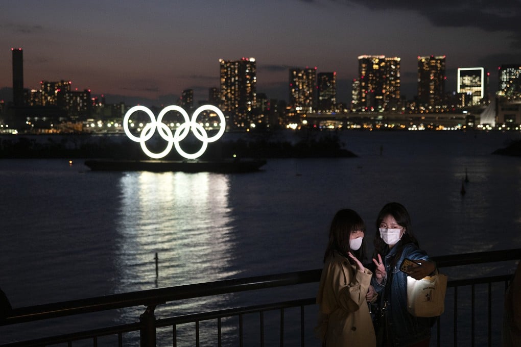 Two women take a selfie in front of the Olympic rings in the Odaiba section of Tokyo. Photo: AP