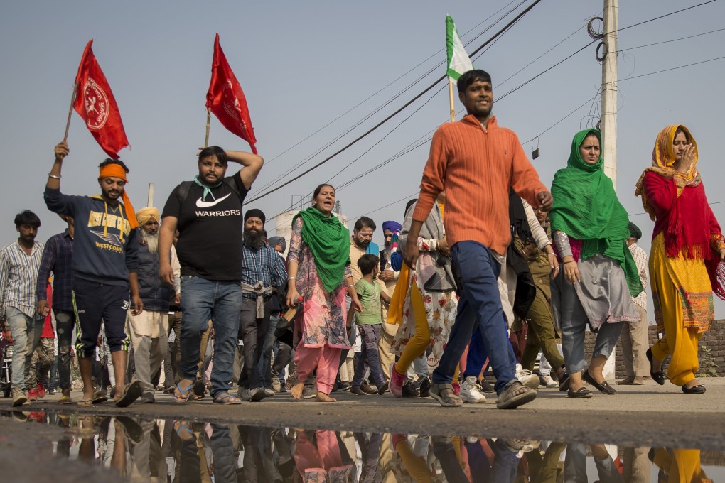 People shout slogans as they join a farmers’ protest at the Delhi-Haryana state border. Photo: AP