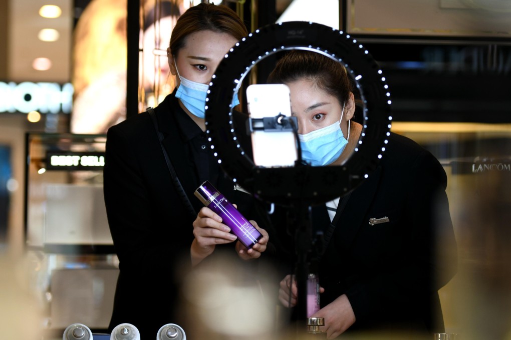 Make-up saleswomen use live-streaming marketing to boost sales during China’s annual November online shopping spree. Many consumers bought products they could not afford on credit. Photo: Xinhua