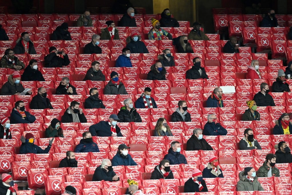 Arsenal fans are socially distanced between blocked seats at the Europa League group B match against Rapid Vienna in London. Photo: EPA