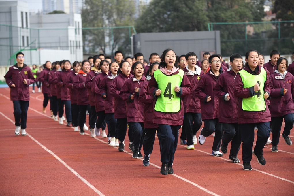 Middle school students run between classes in Guiyang, southern Guizhou province, on October 21. Photo: Getty Images