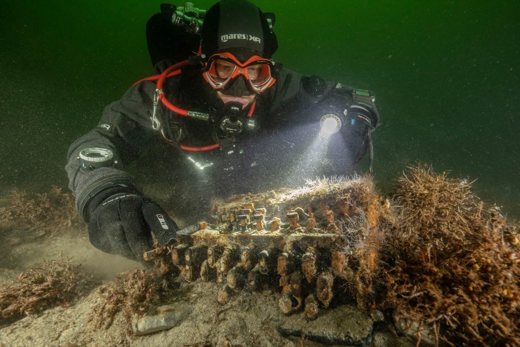 Underwater archaeologist Florian Huber inspects the Enigma encryption machine discovered on November 11 in the Bay of Gelting in the Baltic Sea, northern Germany. Photo: AFP