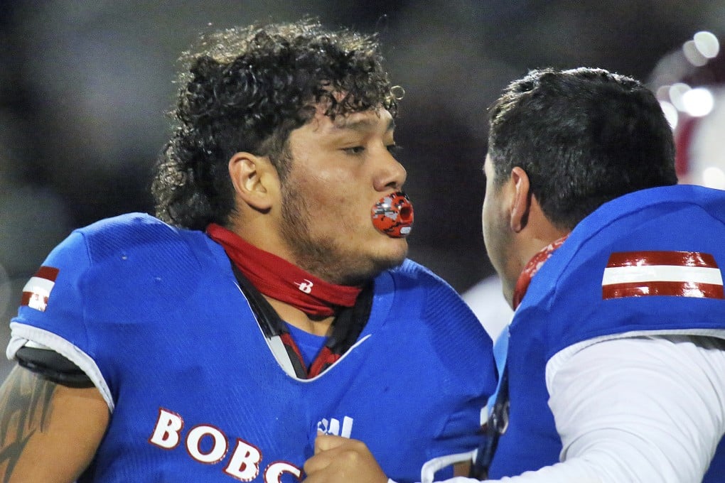 Edinburg's Emmanuel Duron is held back by a teammate after he charged a referee during a high school football zone play-in game against Pharr-San Juan-Alamo in Texas, US. Photo: AP