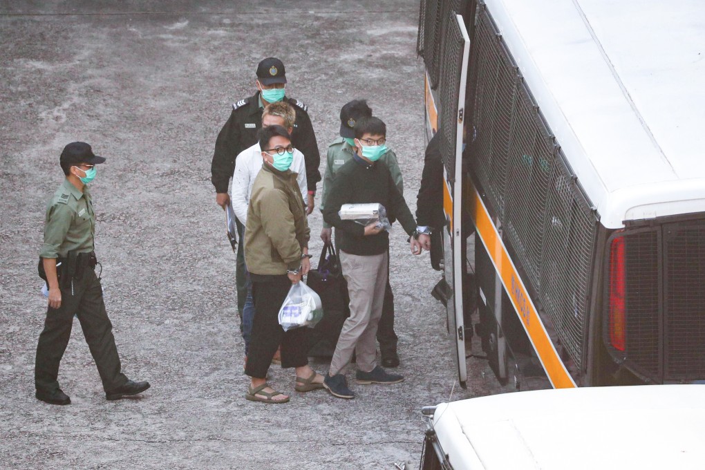 Former Demosisto leaders Joshua Wong (right) and Ivan Lam are seen boarding a vehicle before heading to court on Wednesday. Photo: Sam Tsang