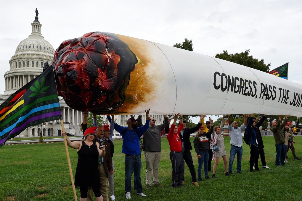 Activists from the DC Marijuana Justice hold a giant inflatable “marijuana joint” to demand Congress pass cannabis reform legislation at the US Capitol in Washington, DC in 2019. Photo: AFP via Getty Images / TNS