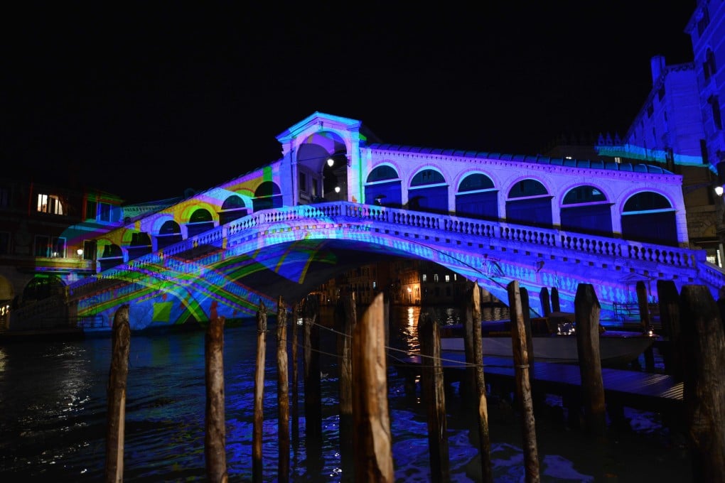 A show projected on to the Rialto bridge in Venice, Italy, presents historical images that recount moments of the city’s history. Photo: AFP