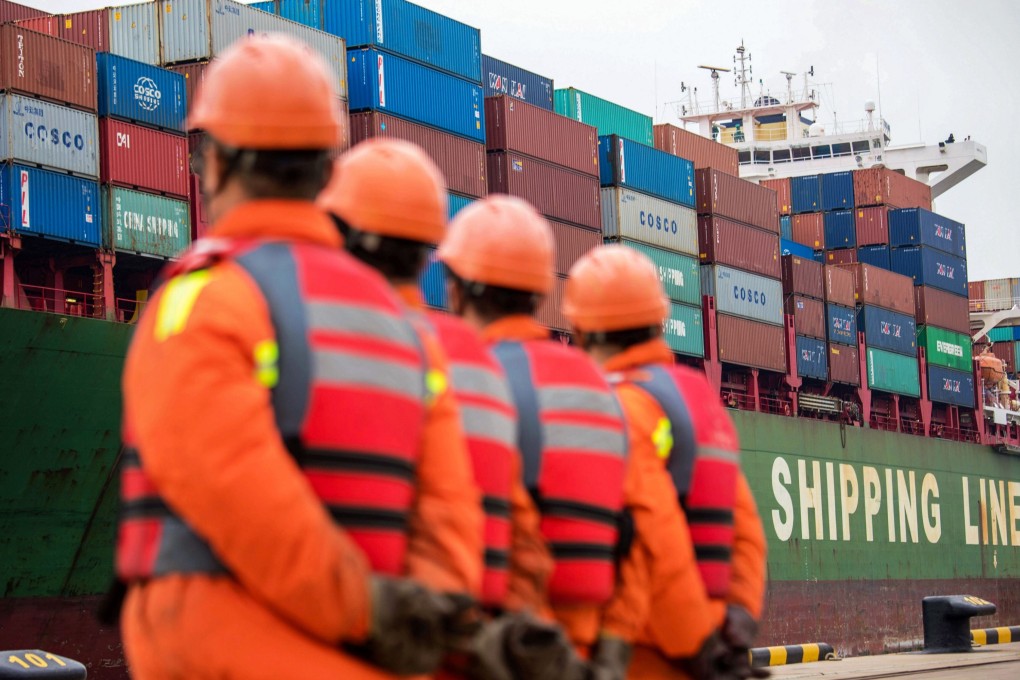 Employees look at a cargo ship at a port in Qingdao, east China's Shandong province in 2018. Photo: AFP