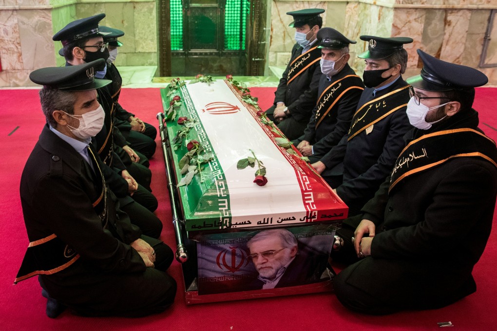 Mourners sit next to the coffin of Iranian nuclear scientist Mohsen Fakhrizadeh during the burial ceremony at the shrine of Imamzadeh Saleh in Tehran in November. Photo: West Asia News Agency via Reuters