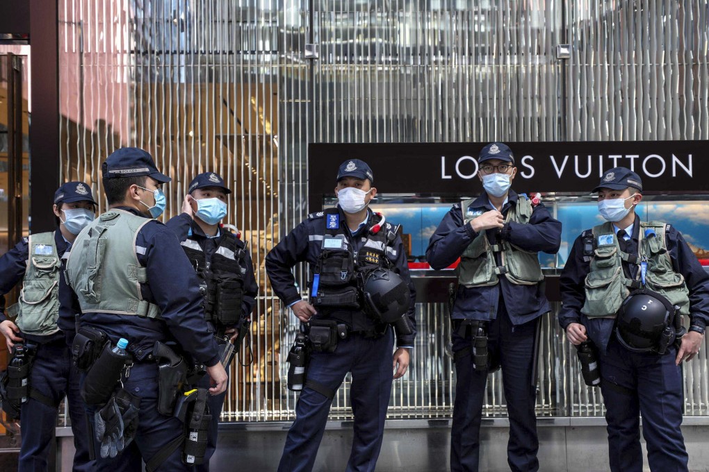 Police officers stand guard in Central during a lunchtime rally on February 21. In one case that was successfully prosecuted under the Personal Data (Privacy) Ordinance, the personal data of a family member of a police officer was disclosed to a group on social media for doxxing. Photo: Xiaomei Chen