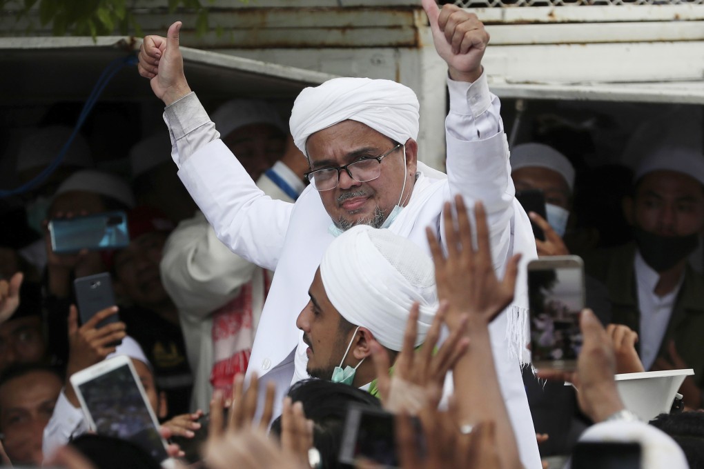 Indonesian Islamic cleric and the leader of Islamic Defenders Front Habib Rizieq Shihab gestures to his followers as he arrives home from Saudi Arabia on November 10. Photo: AP