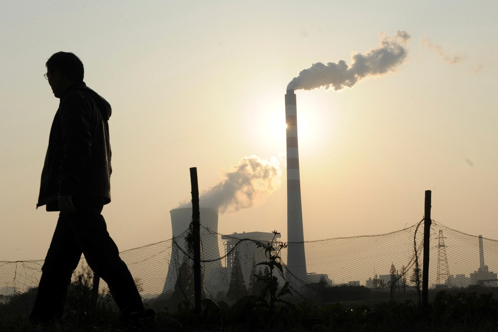 A man walks past a power station in China’s Anhui province. Major energy producers have championed carbon capture and storage as a means to curb emissions footprints. Photo: Reuters