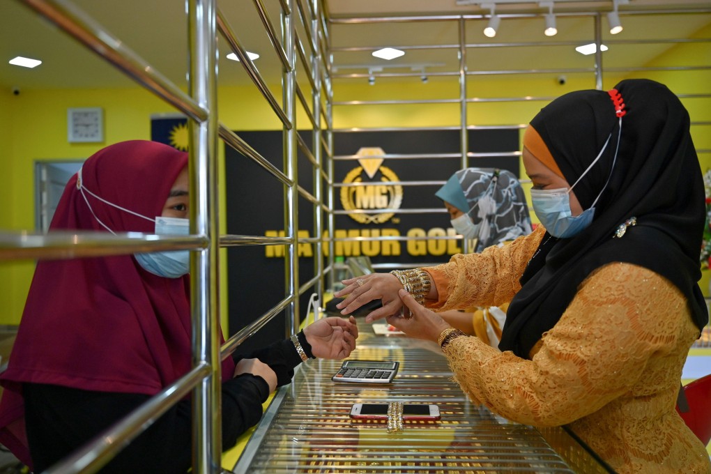 A customer trying on a bracelet at the Makmur Gold shop in Kota Bharu in Malaysia’s Kelantan state. Photo: AFP