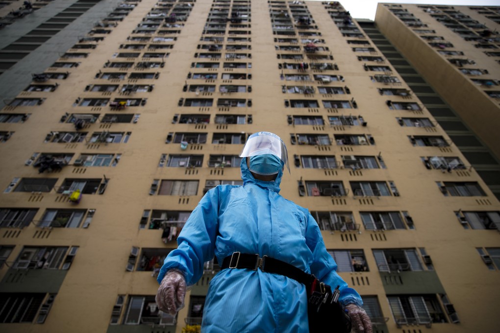 A security guard in protective gear stands outside Kwai Shing West Estate in Kwai Chung. Photo: Winson Wong