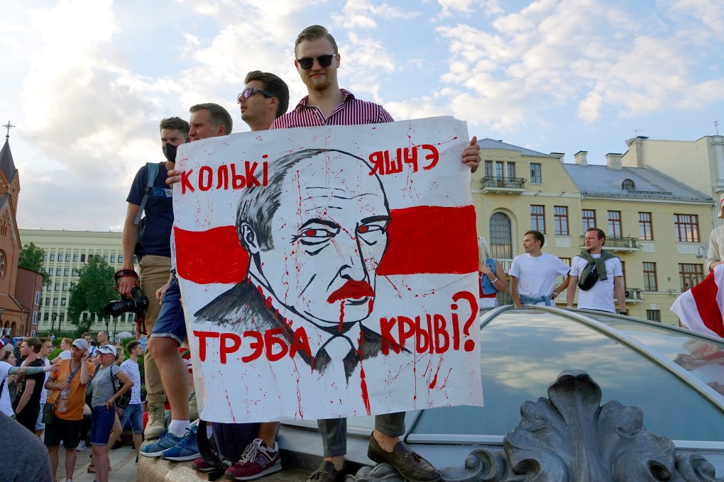 A man holds a poster reading “How much more blood will it take?” during protests against Belarusian President Alexander Lukashenko in August. Photo: dpa