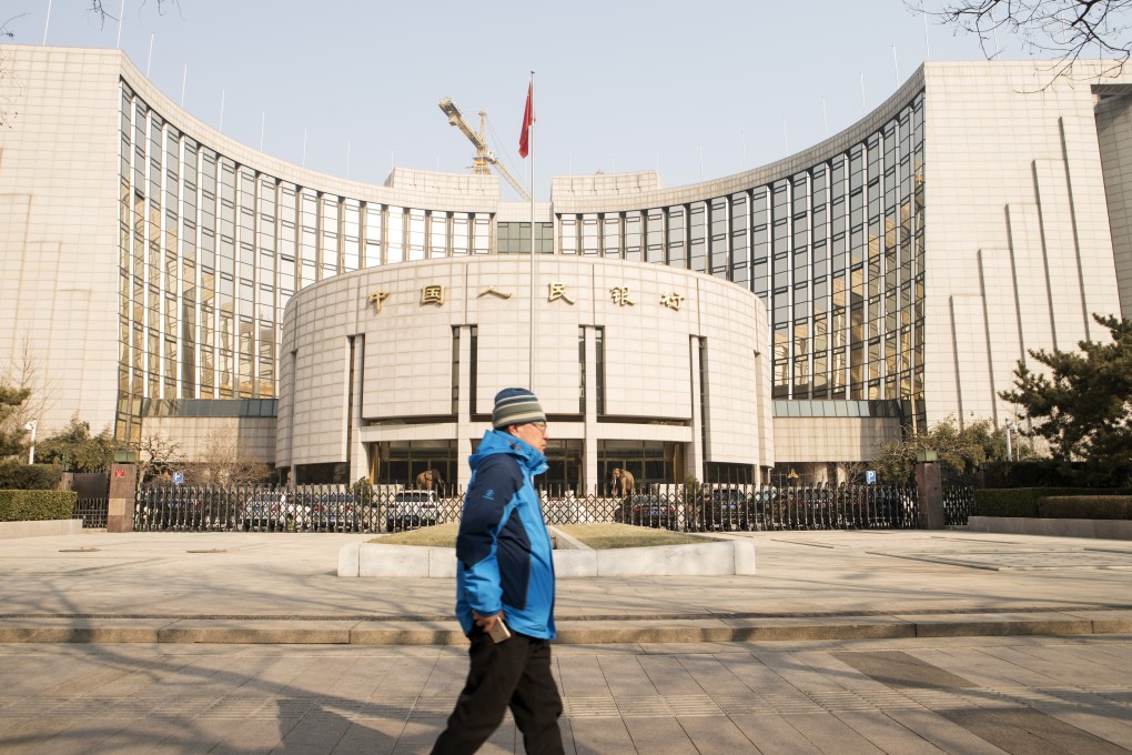 A pedestrian walks past the People's Bank of China headquarters in Beijing. Photo: Bloomberg