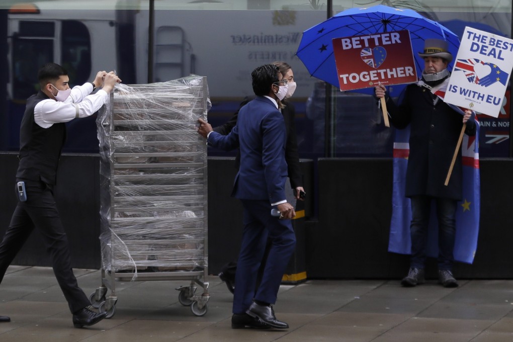 Staff from The Conrad hotel deliver food to the London conference centre where officials were meeting for Brexit trade talks. Photo: AP