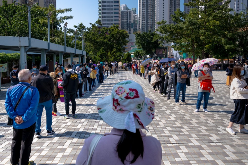 People maintain social distancing while standing in line at a community testing centre in Hong Kong on December 5, amid a worsening fourth wave of Covid-19. Photo: Bloomberg