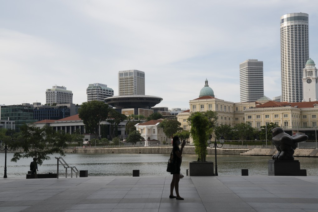 A view of the present (left) and past Supreme Court buildings from the Singapore River. Photo: Bloomberg