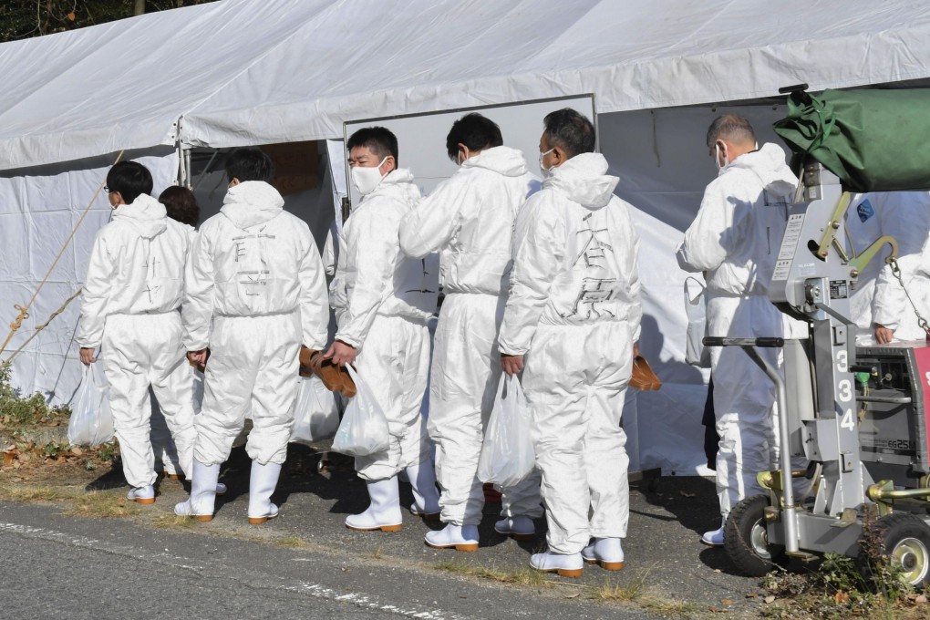 Officials in protective suits are pictured in Mihara in Hiroshima Prefecture ahead of the culling of thousands of chickens at a farm where an outbreak of bird flu was confirmed. Photo: Kyodo