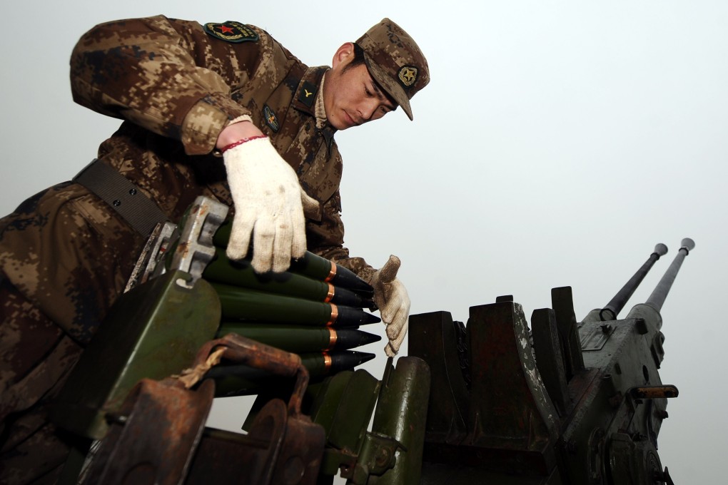 A Chinese soldier loads cloud-seeding shells during a weather modification mission in northern Shanxi province in February 2011. Photo: Xinhua