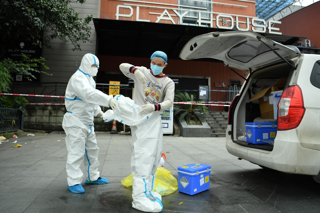 Workers in protective suits outside a nightclub which was closed after new cases of the coronavirus in Chengdu, Sichuan province, southwest China. Photo: Reuters