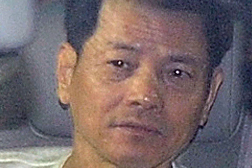“Broken Tooth” Wan Kuok-koi is driven away from prison in Macau in December 2012. Photo: AFP