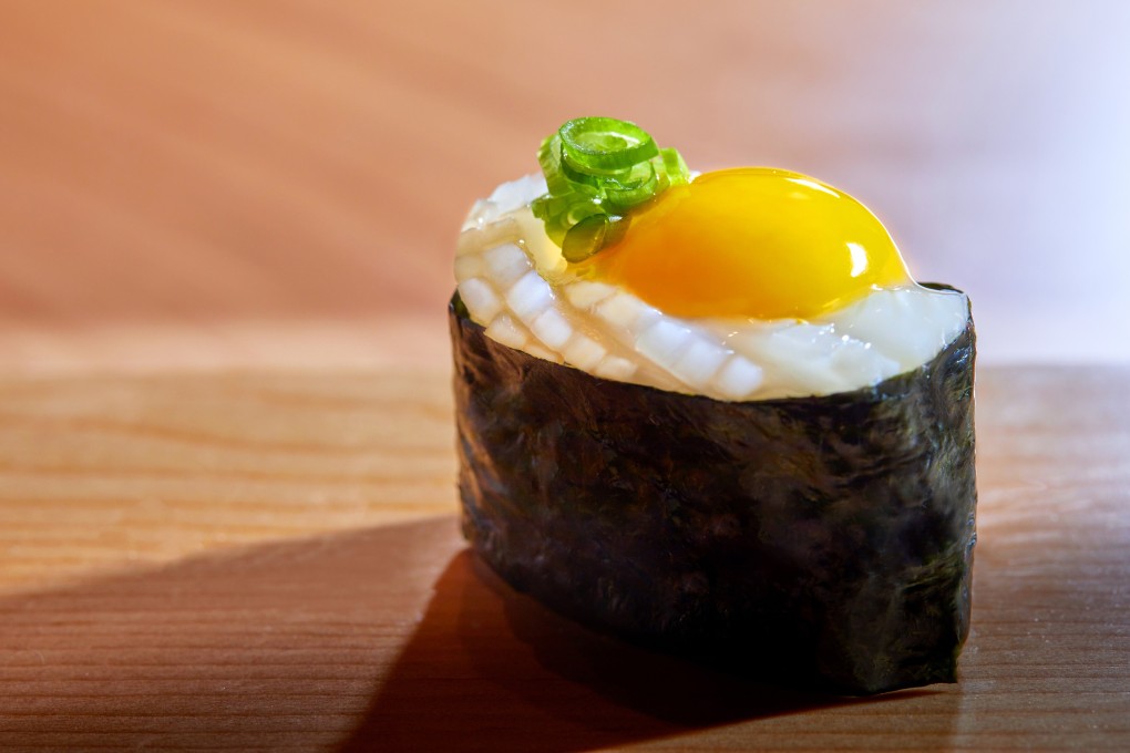 Sushi Hakucho’s ika and quail egg yolk sushi. Photo: handout