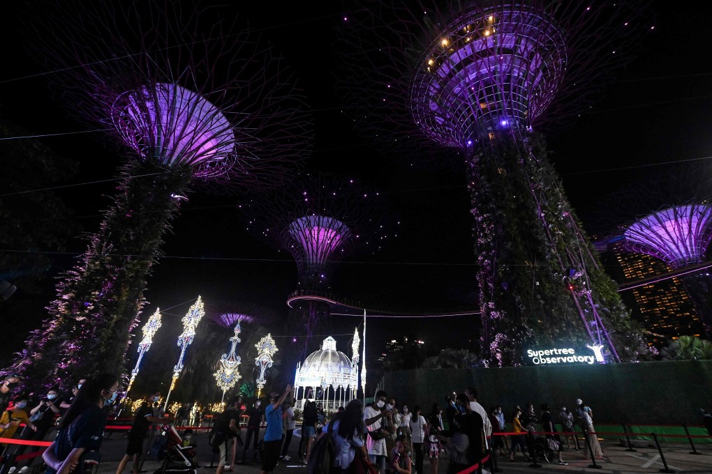 Visitors walk through Christmas light installations at Gardens by the Bay in Singapore. Photo: AFP