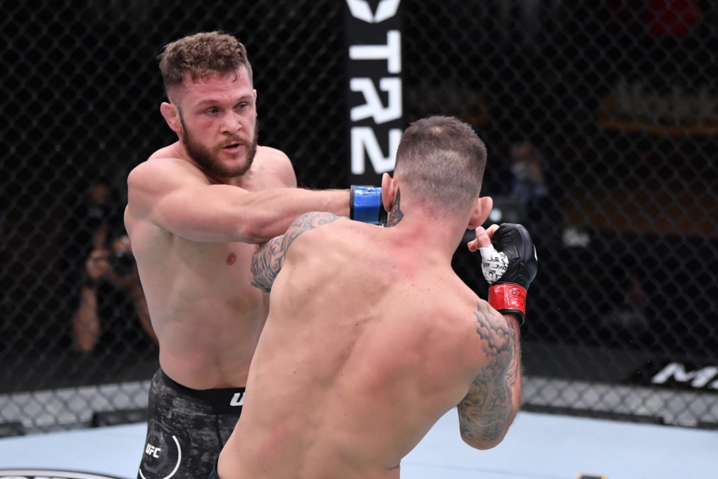Rafael Fiziev punches Renato Moicano in their lightweight bout during UFC 256. Photos: Jeff Bottari/Zuffa LLC