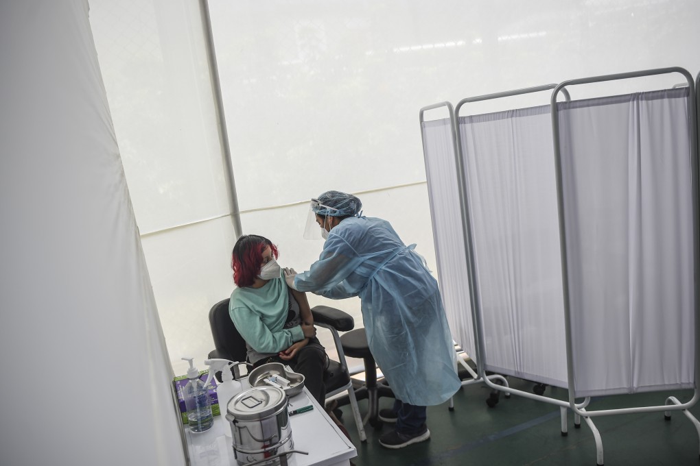 A health worker inoculates a volunteer with Sinopharm’s Covid-19 vaccine during its trial at the Clinical Studies Centre of the Cayetano Heredia University in Lima, Peru. Photo: AFP