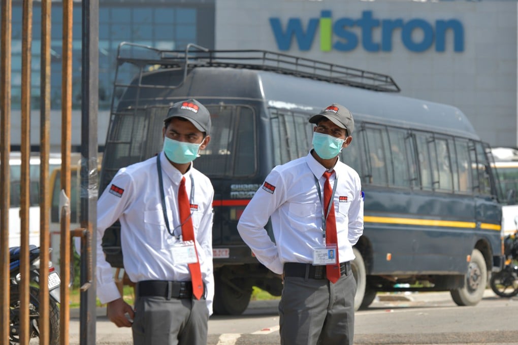 Private security guards stand at the entrance of the Taiwanese-run iPhone factory at Narsapura on Sunday. Photo: AFP