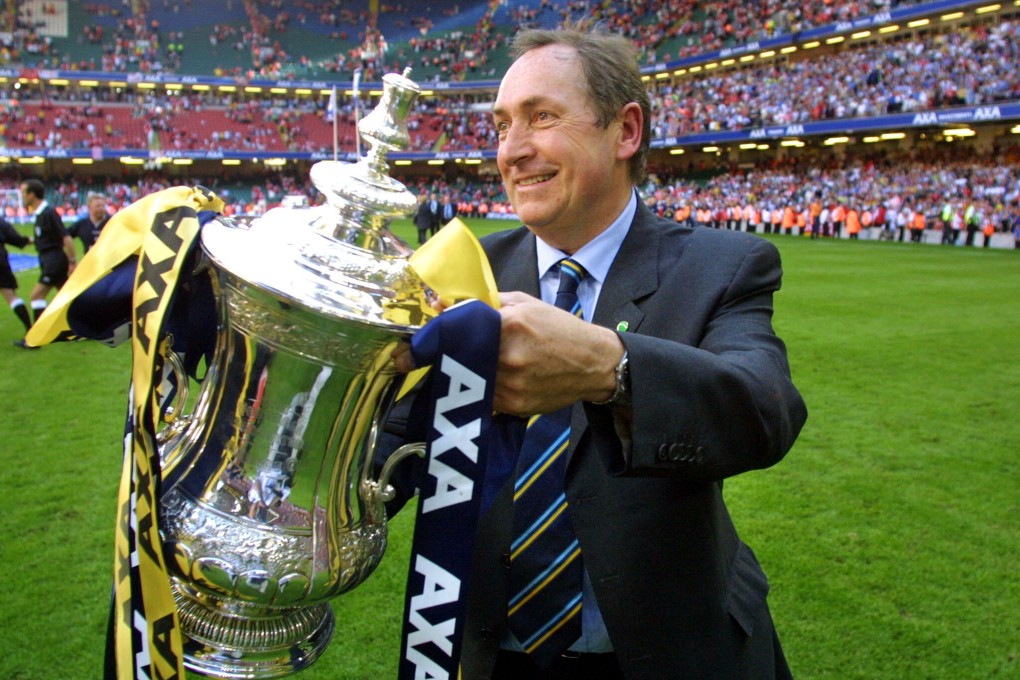 Liverpool manager Gerard Houllier holds the FA Cup trophy after his team beat Arsenal in the 2001 final at the Millennium Stadium in Cardiff. Photo: AFP