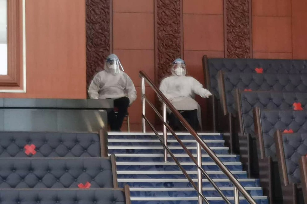 Malaysia’s health minister and human resources minister pictured in the country’s parliament wearing personal protective equipment on Monday. Photo: Handout / Teresa Kok / AFP