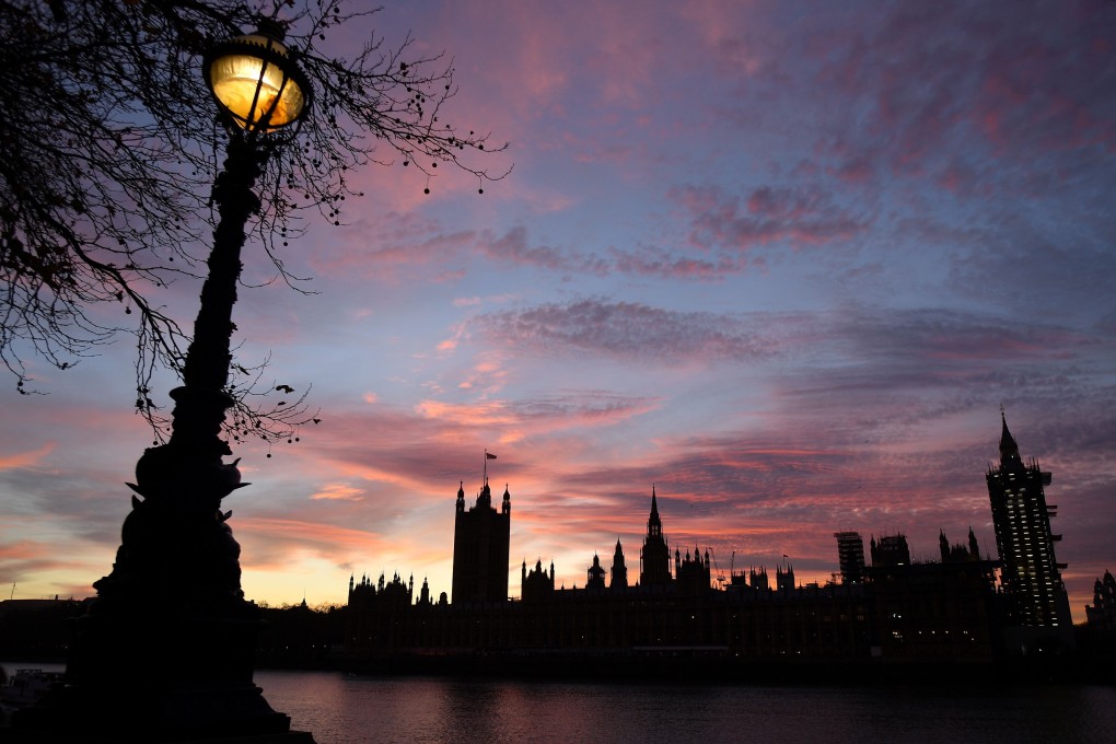 The sun sets behind the Palace of Westminster, comprising both houses of the British parliament, the House of Commons and the House of Lords, in central London. Photo: AFP